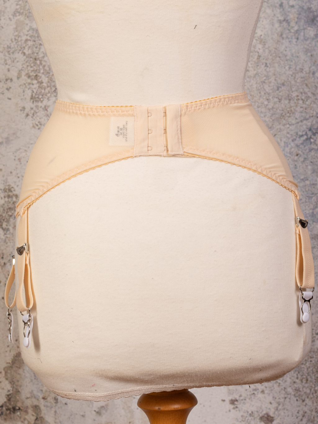 Close up back view of peach celia suspender belt