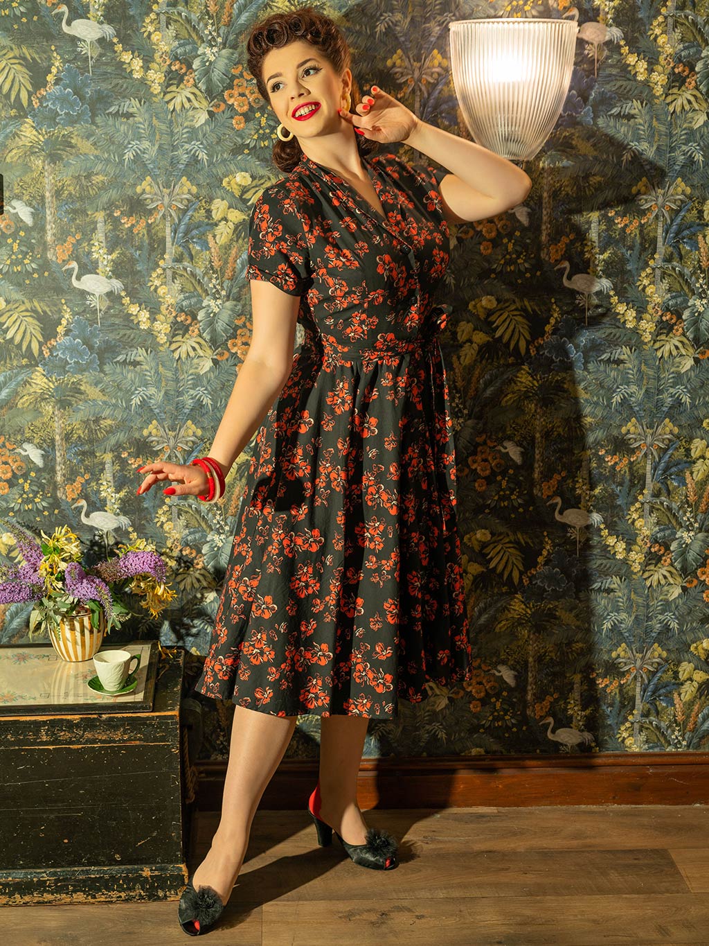 1950s shirt waist dress in a red and cream floral print on black background