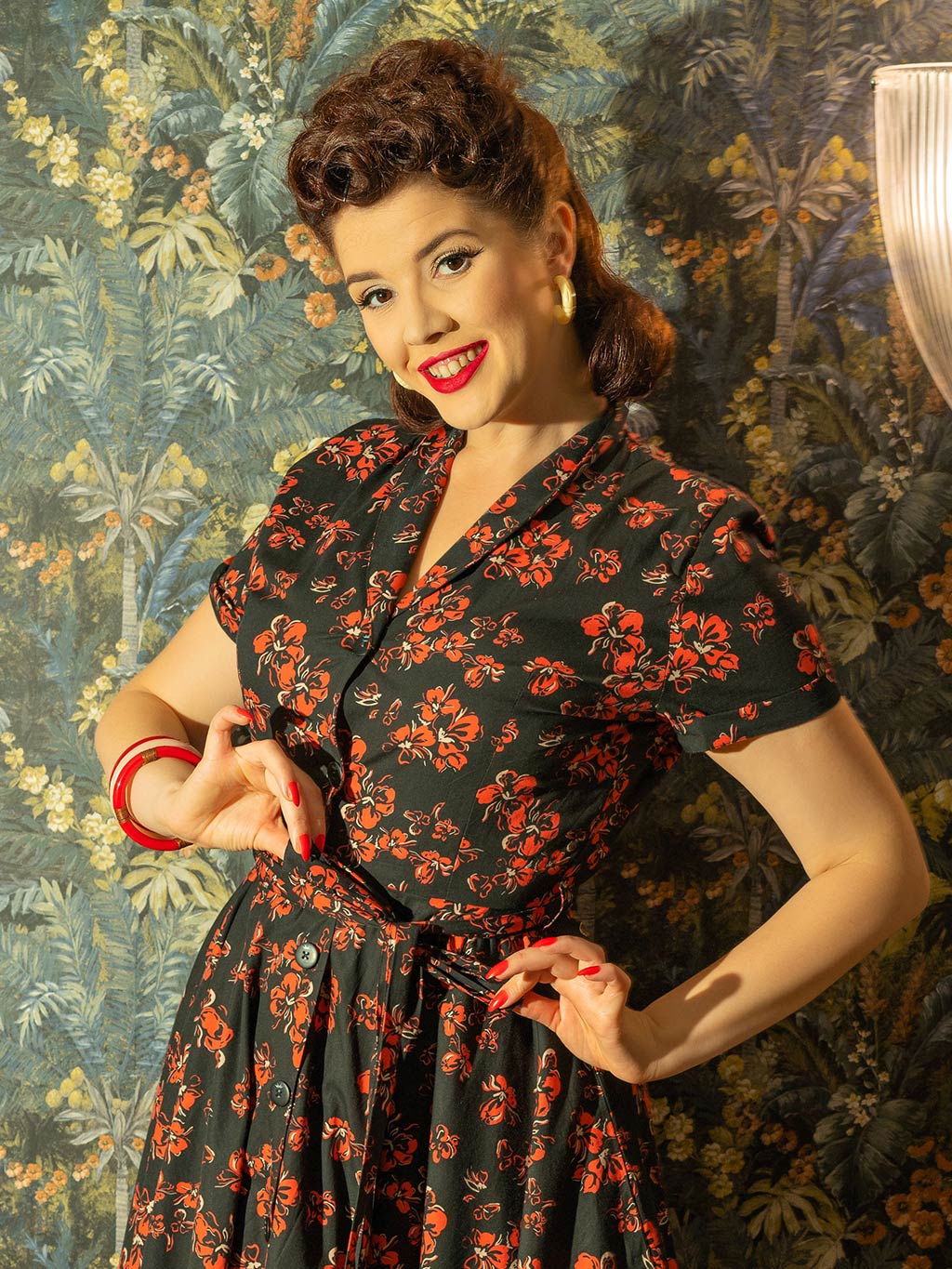 1950s shirt waist dress in a red floral print on black background