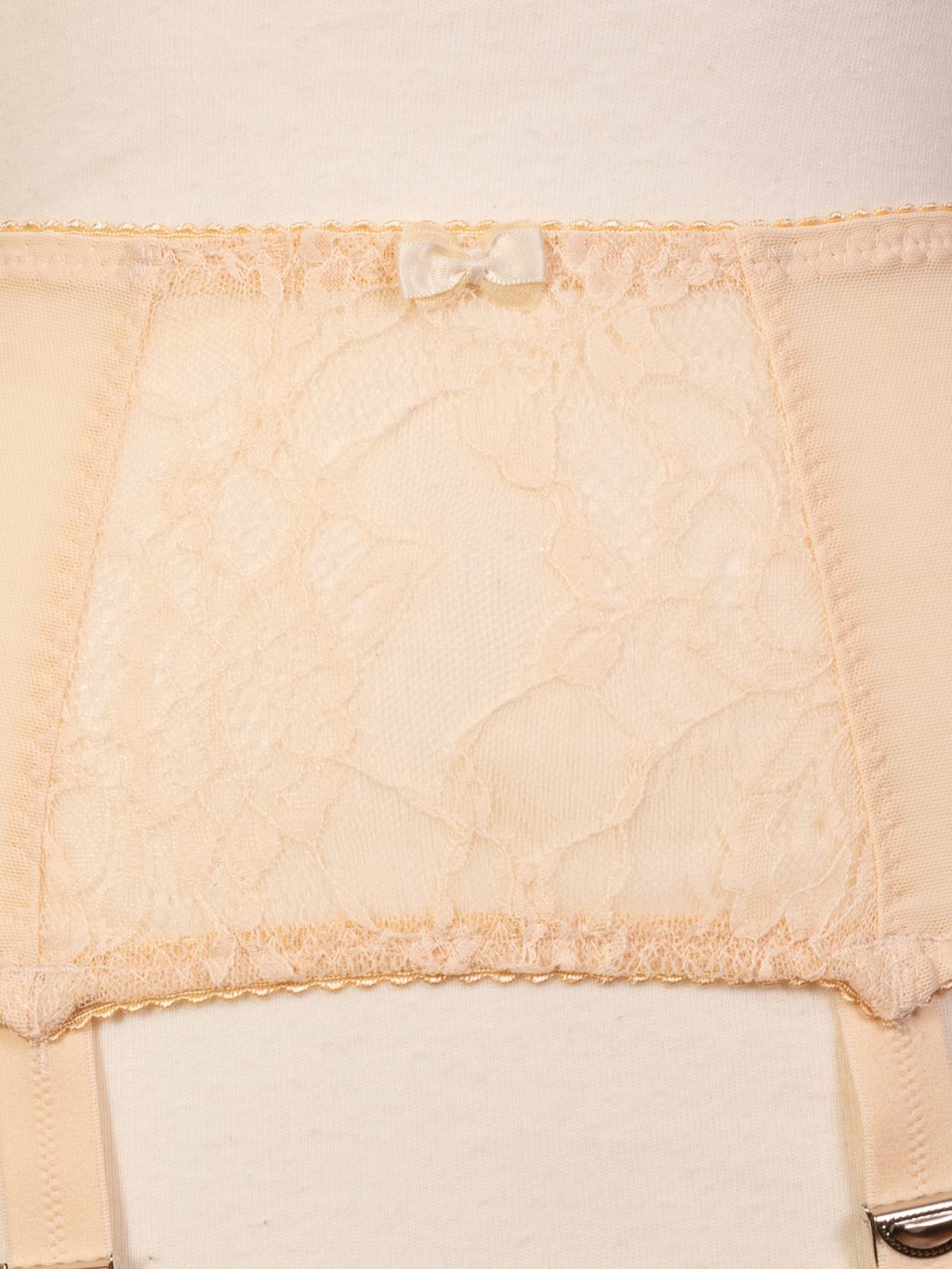 Close up of lace detailing on Celia peach suspender belt.