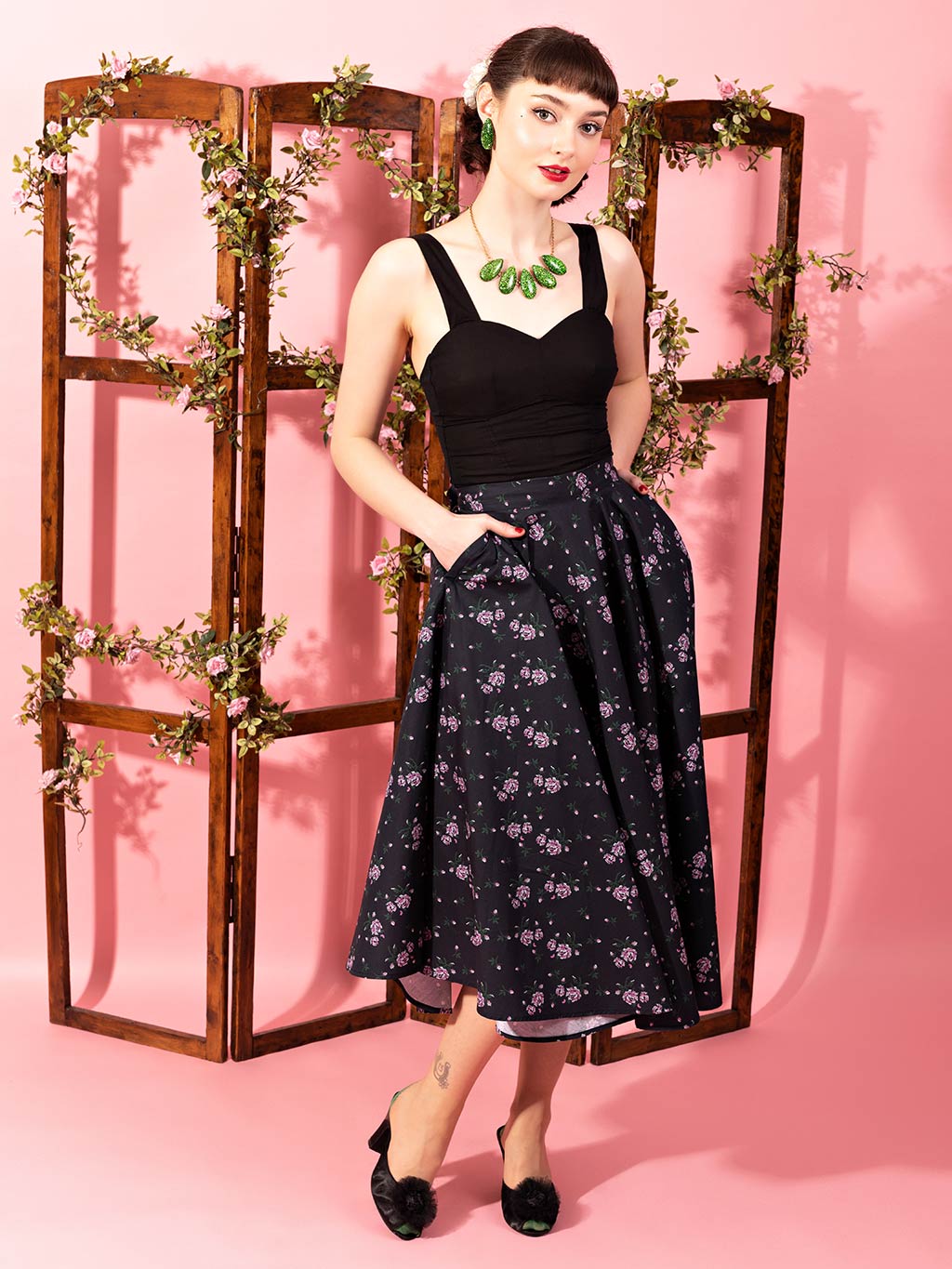 pink and green needlepoint print on a black 1950s circle skirt