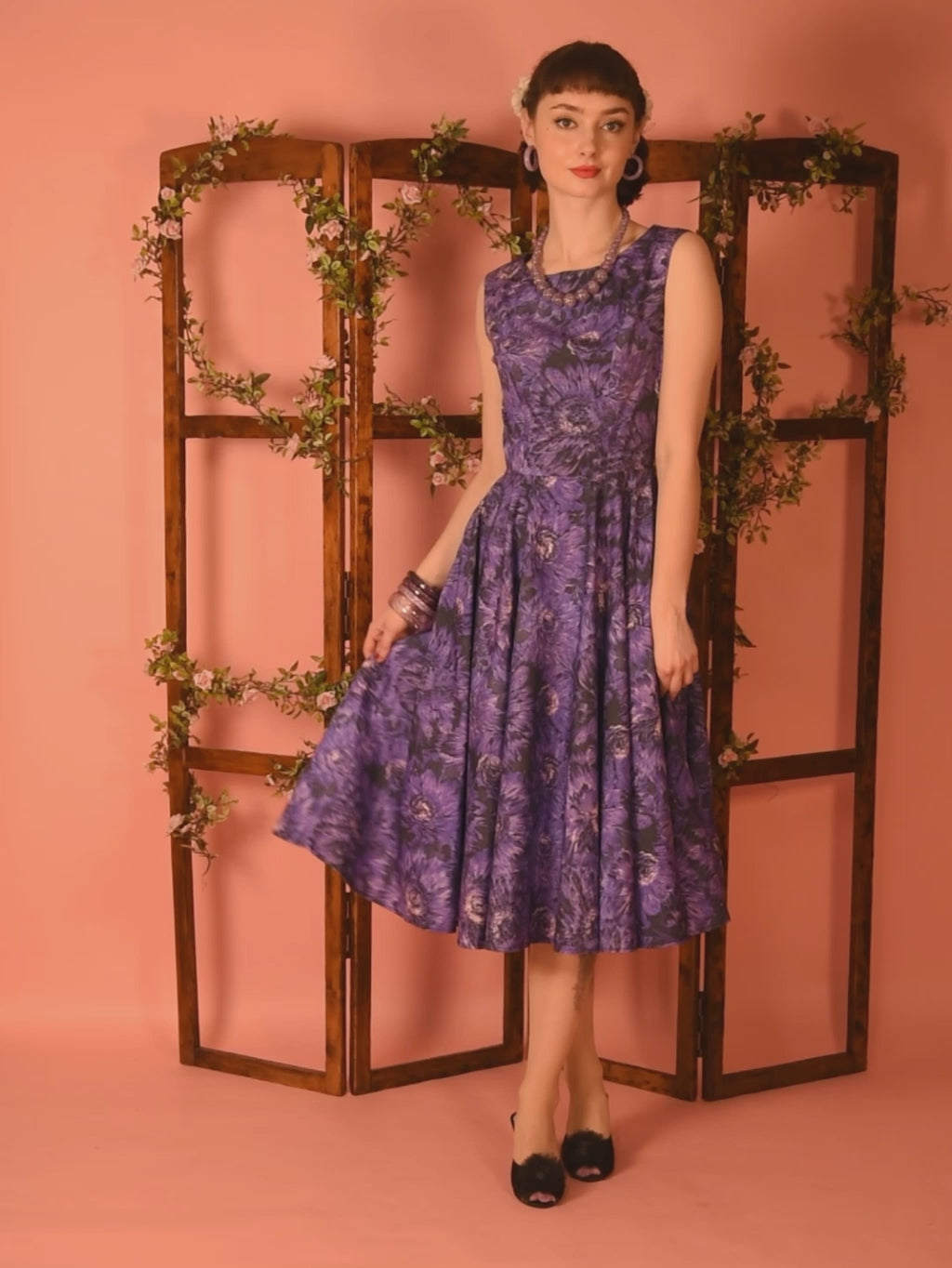 1950s dress in purple floral print, with full circle skirt.