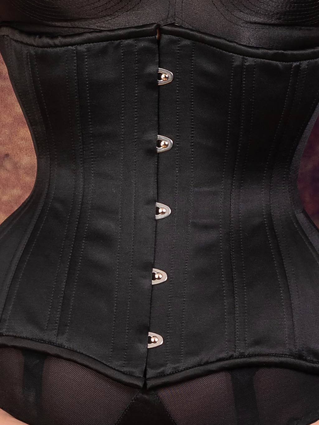 close up of a curve black underbust corset busk