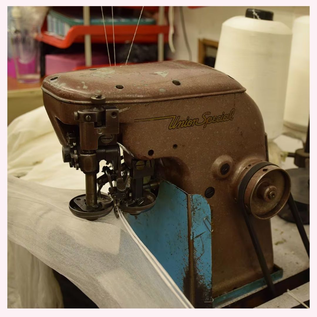 close up of a overlock machine sewing seams on fully fashioned stockings