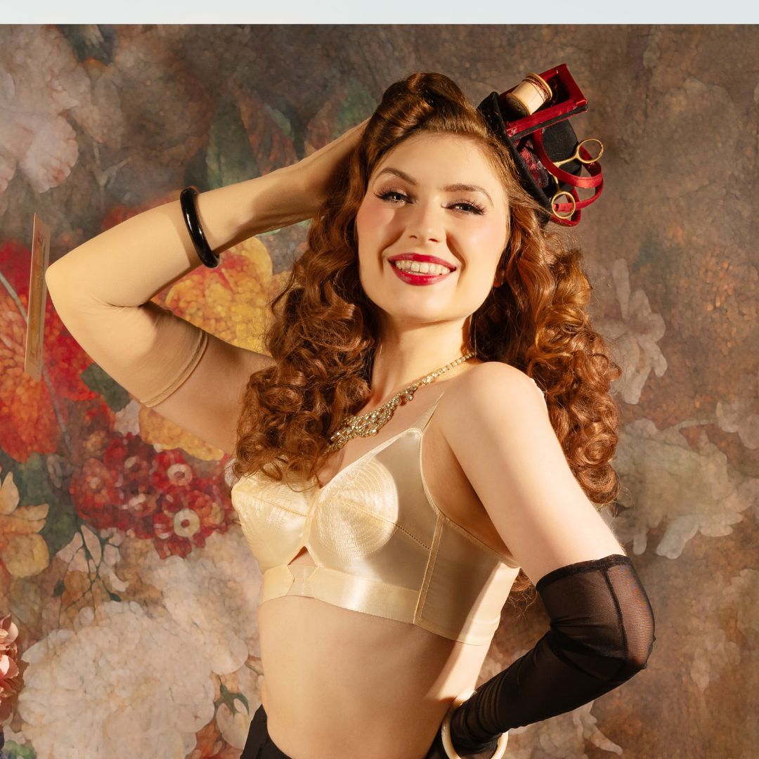 1950s peach satin bullet bra worn with a matching waist cincher