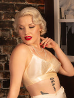 Woman in a vintage style CC41 inspired peach bra.