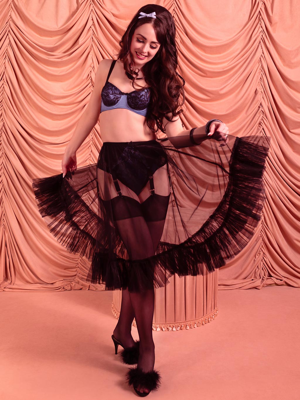 1950s black frilly nylon petticoat worn with black stockings and vintage blue lingerie