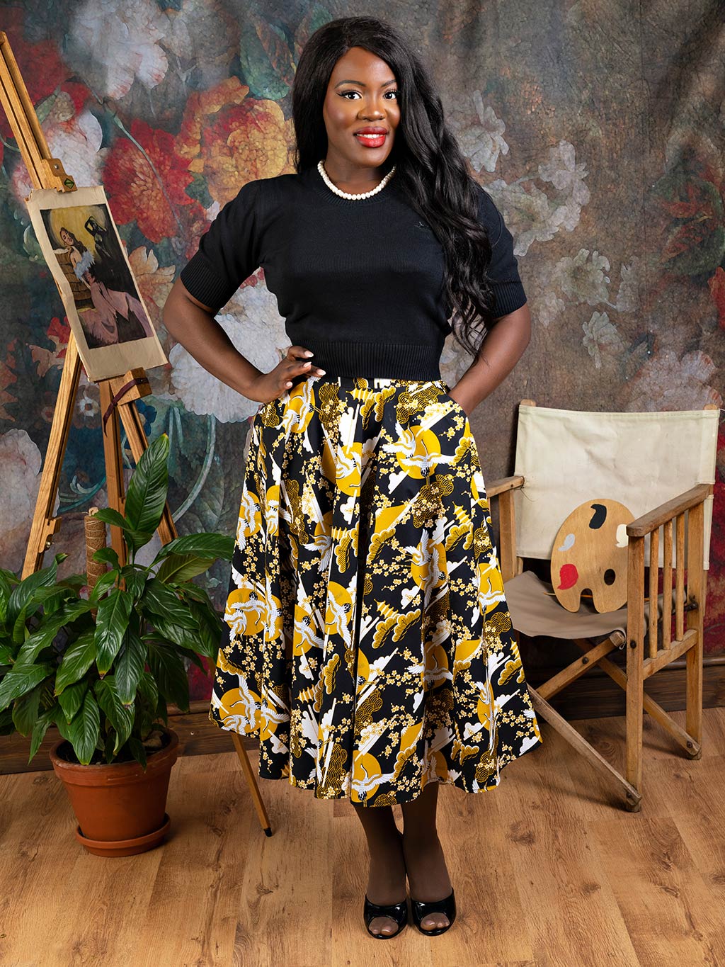 1950s circle skirt in a mustard crane print worn with a black short sleeve jumper