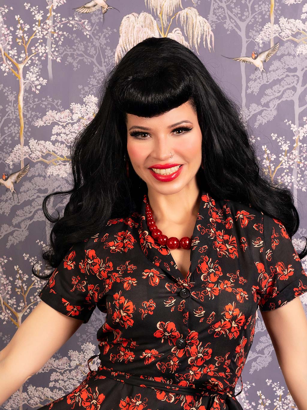 Close up of a 1940s 1950s shirt waist dress with shawl collar, in red, cream and white floral print