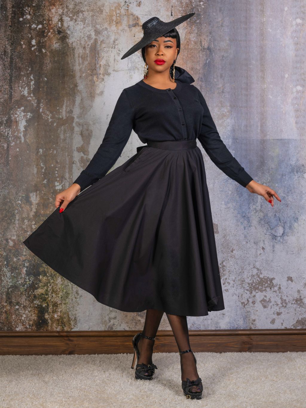 black 1950s black cotton circle skirt worn with matching black cardigan