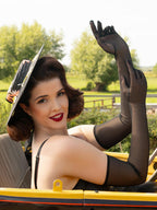 long black sheer gloves worn with a black vintage straw hat