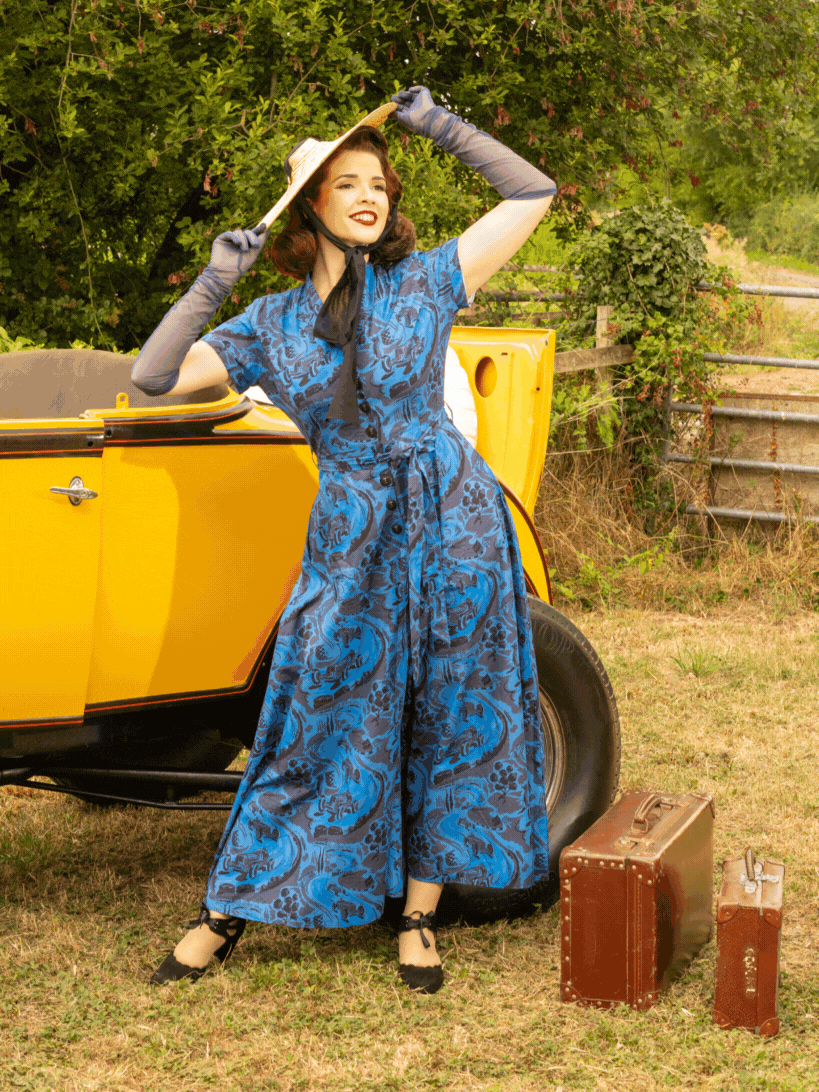 model wearing vintage blue beach pyjamas in front of a 1940s hotrod.