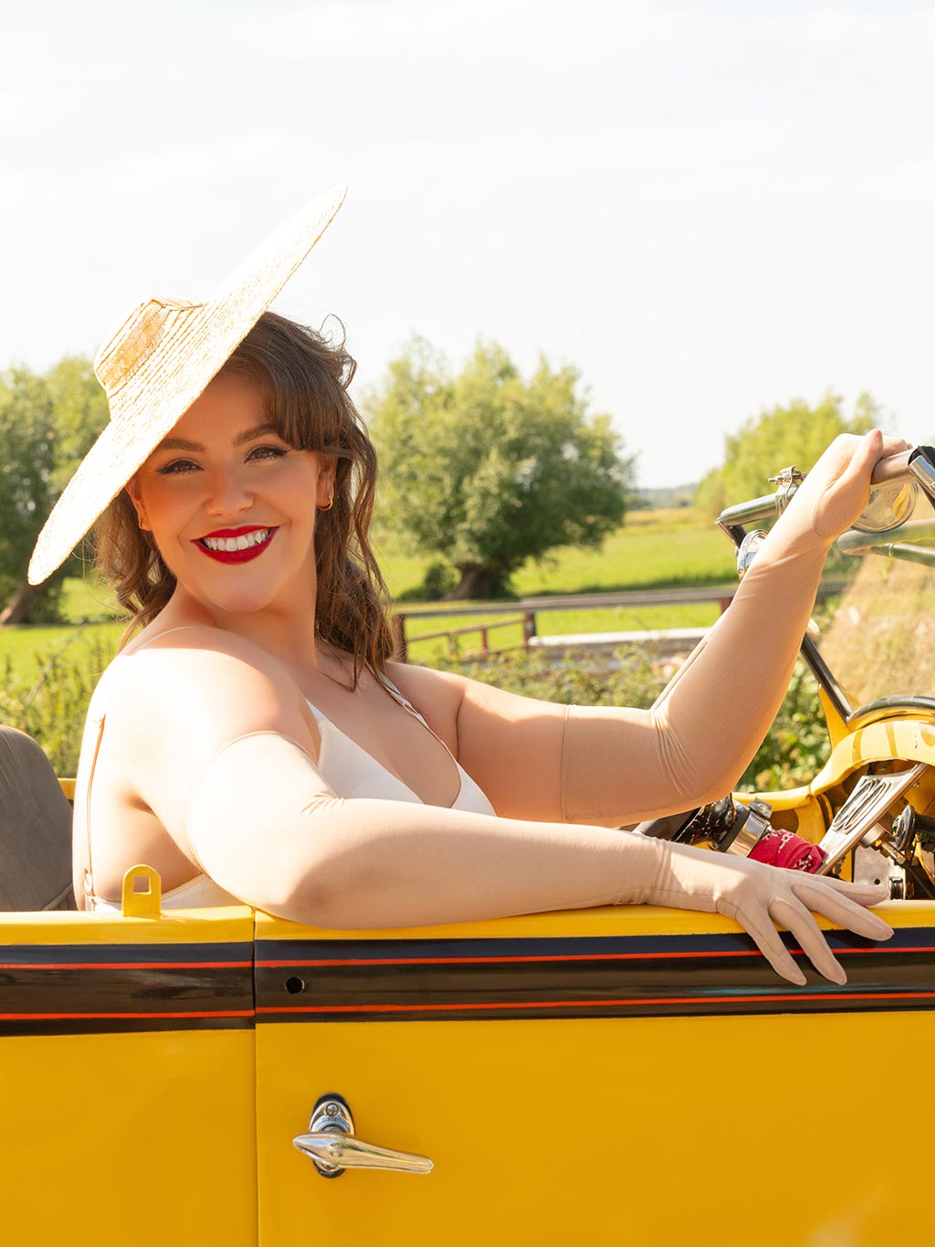 long champagne mesh evening gloves worn with a vintage straw hat