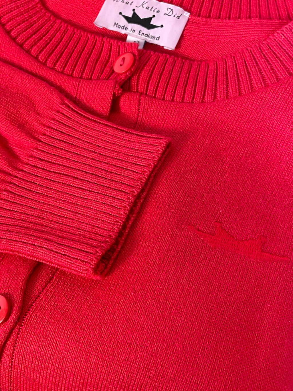 close up of red crown stitch detailing
