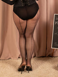 Person wearing black seamed fishnet tights and high heels in front of a beige curtain.