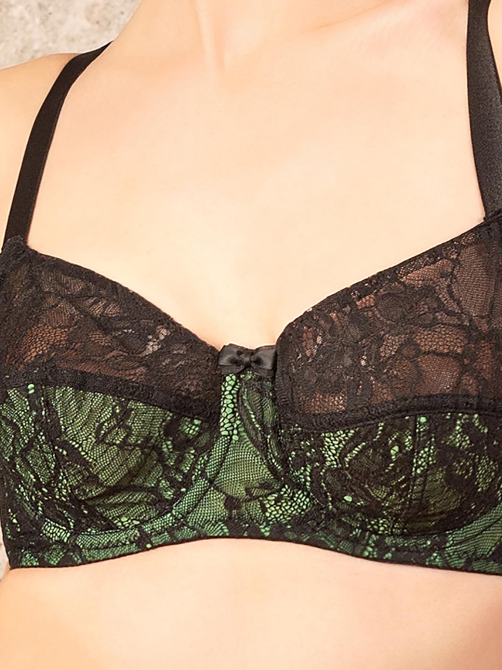close up vintage green bra with black lace overlay 