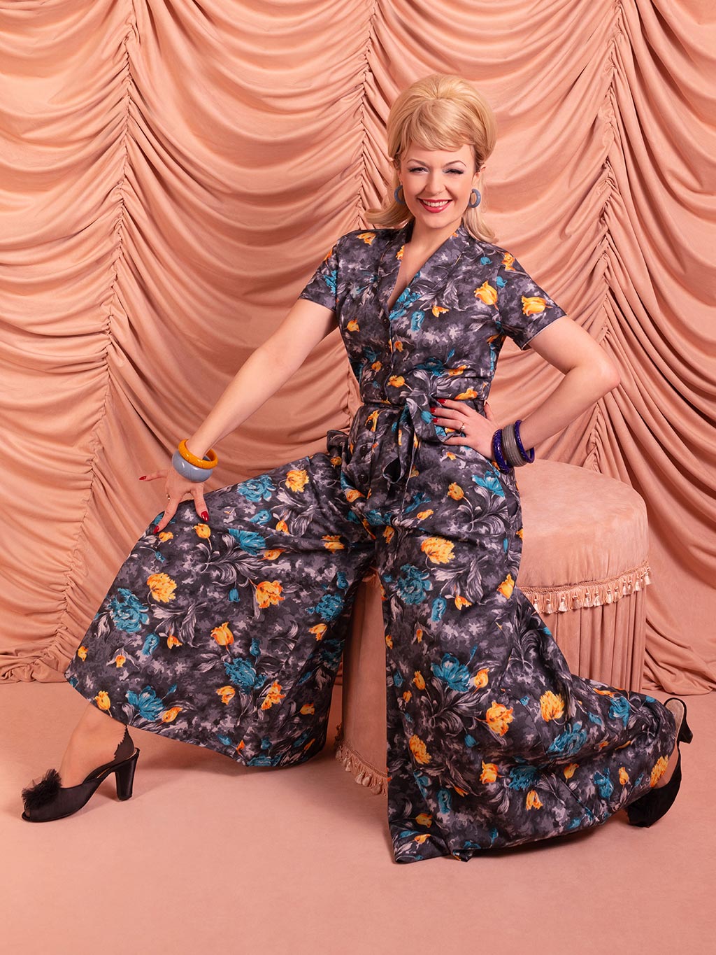 Model sitting in Lucy retro beach pyjamas in 1950s pink boudoir setting