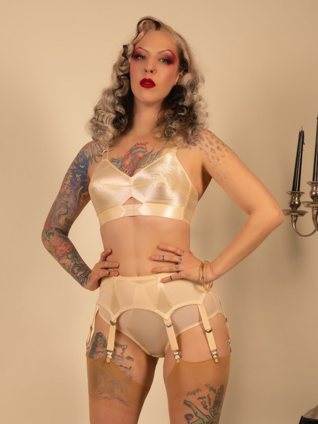Woman wearing vintage-style lingerie against a neutral background