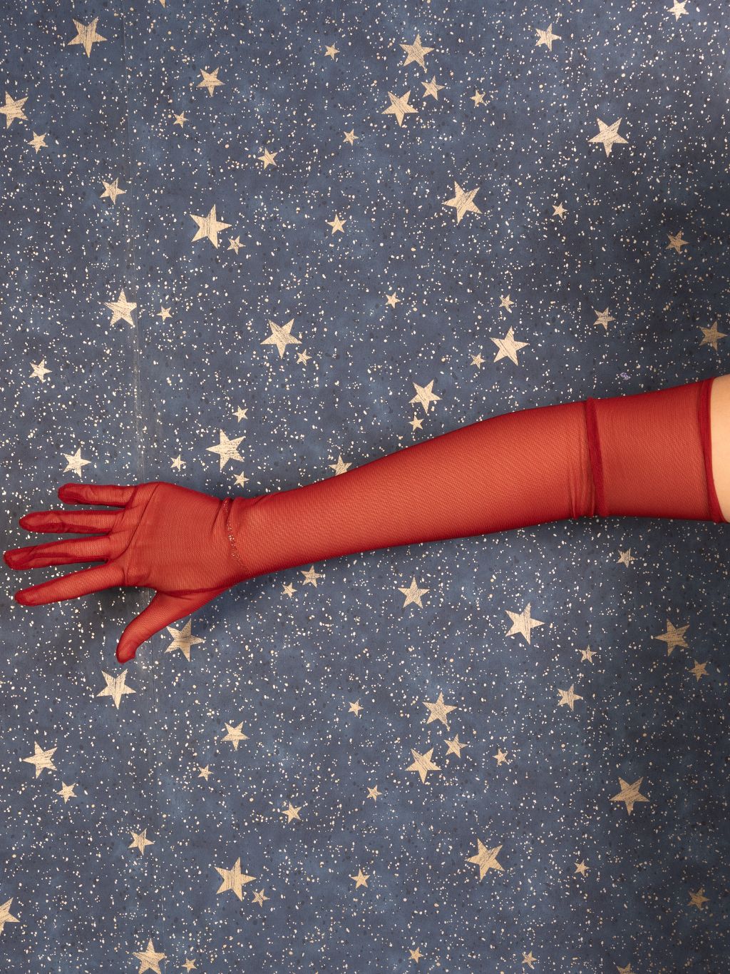 Red glove on a star-patterned blue background