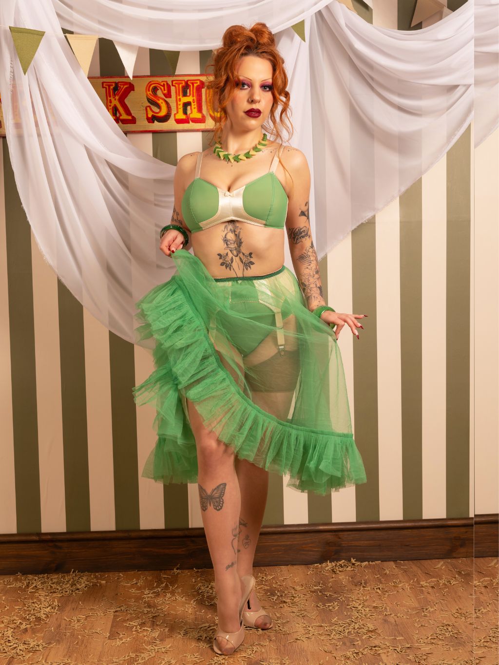 sheer green frilly petticoat worn with matching lingerie and seamed stockings