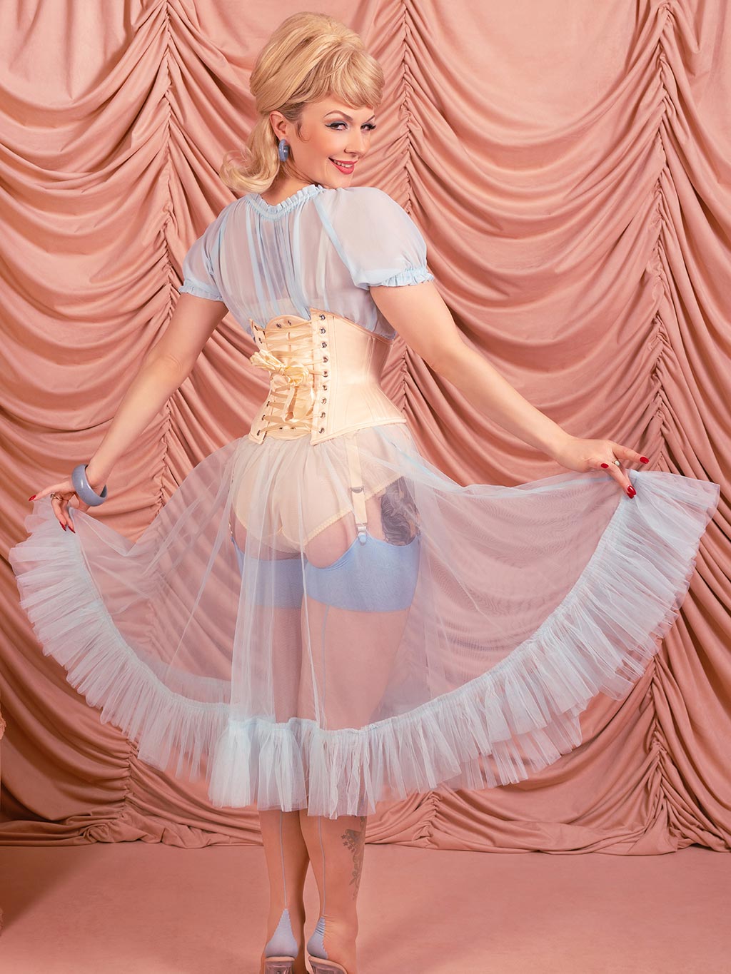 peach satin waspie corset worn with blue bardot top and frilly petticoat