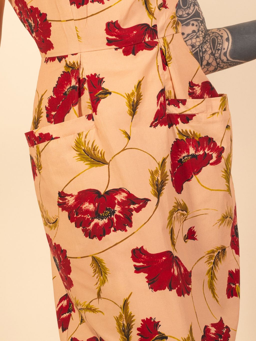 Floral dress with red flowers on a beige background