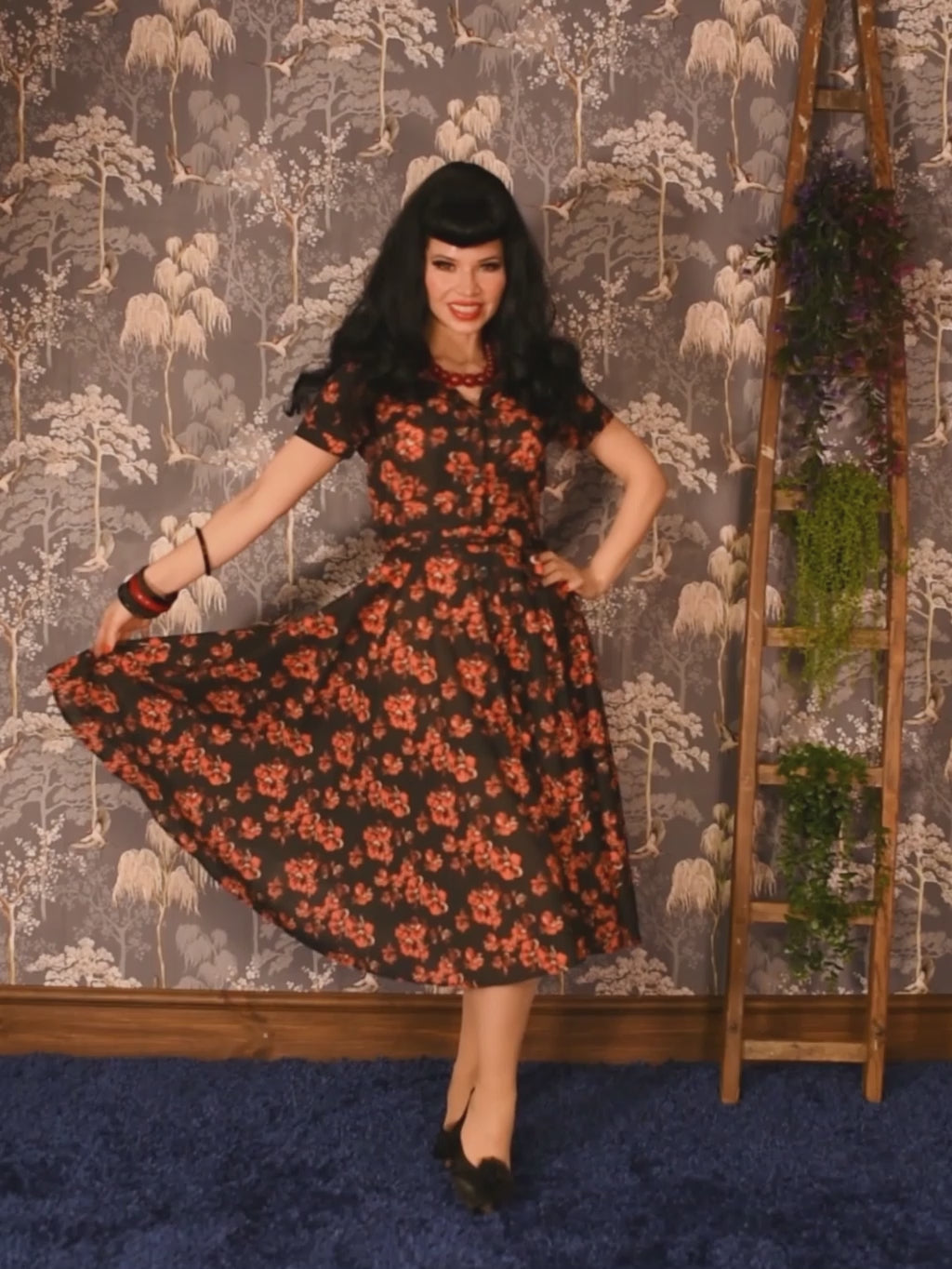 1940s 1950s shirt waist dress in a vintage red and cream floral print on black background