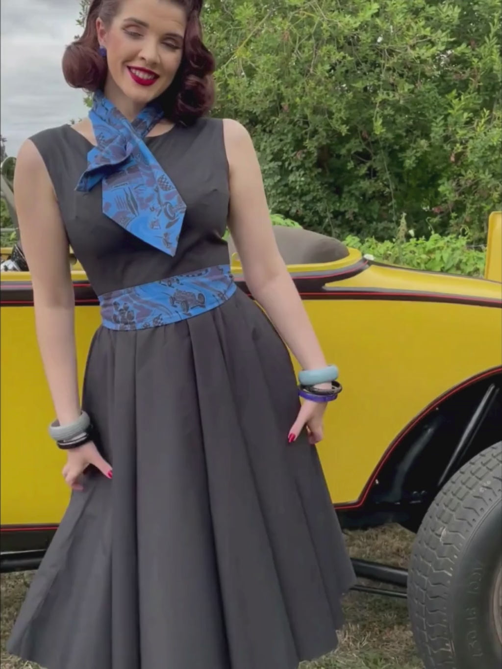 1950s black dress worn with blue belt 