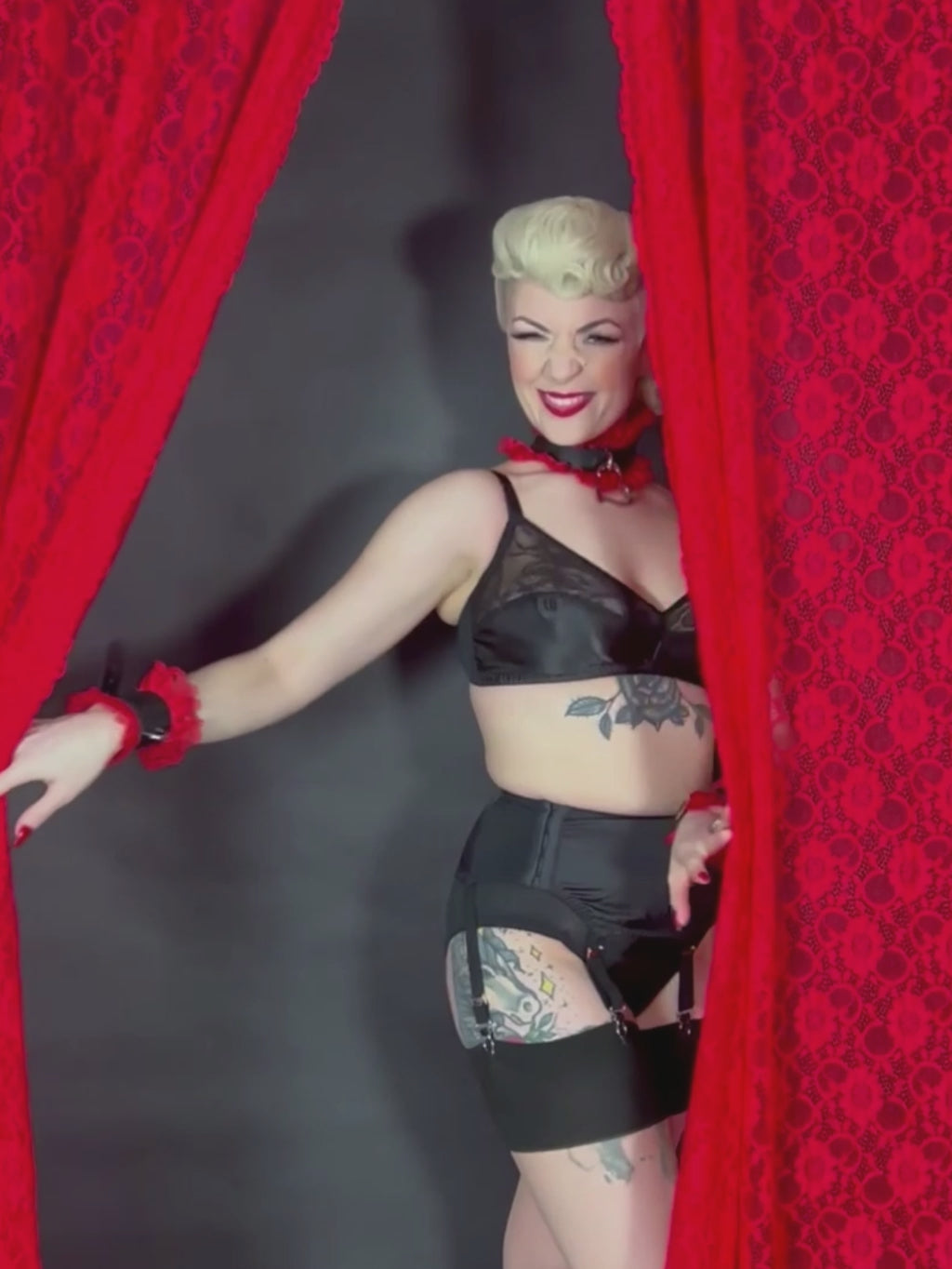 black satin 1940s suspender belt worn with matching bra