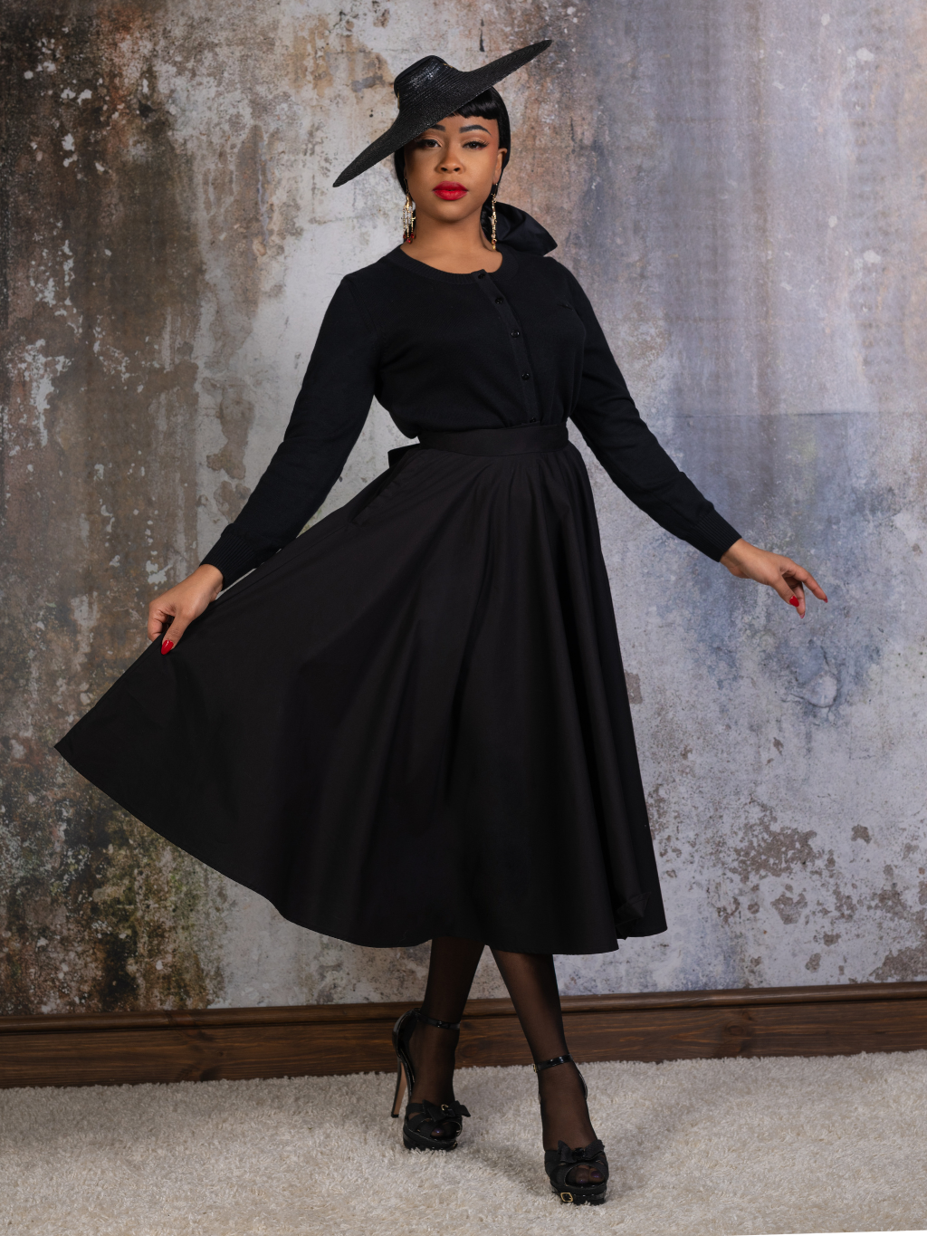 black 1950s black cotton circle skirt worn with black seamed stockings