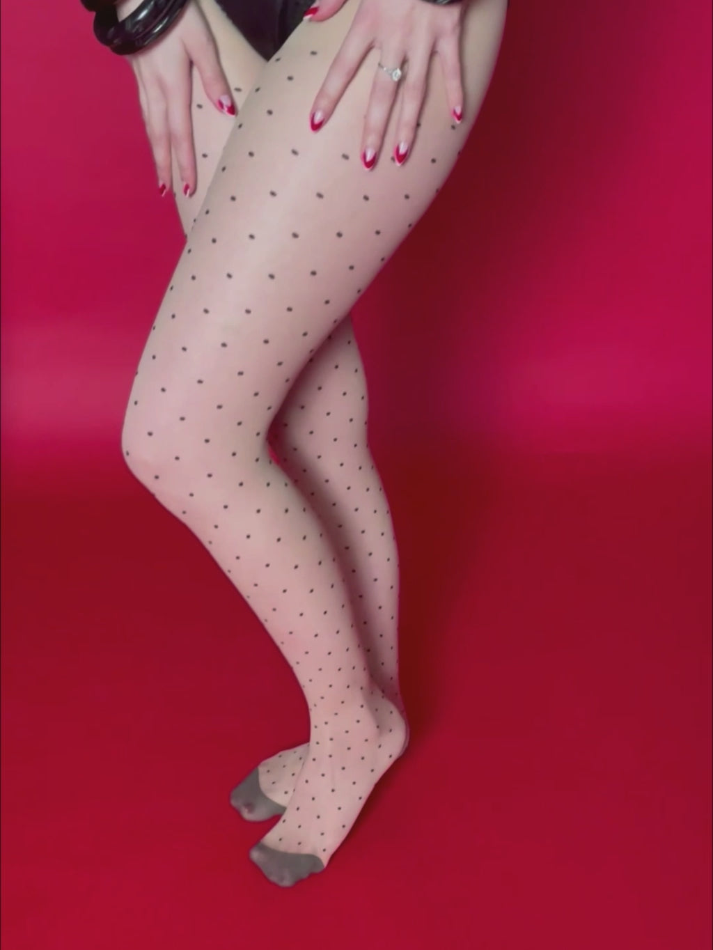 1950s polka dot seamed tights worn with black satin lingerie