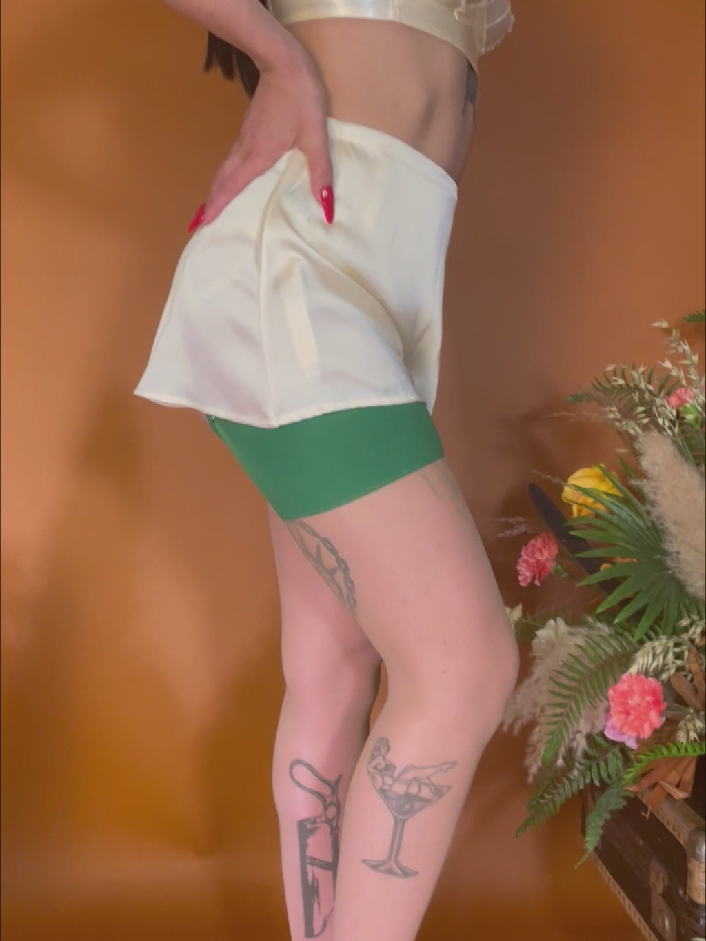 1940s peach satin french knickers worn with matching 1940s bra and green stockings
