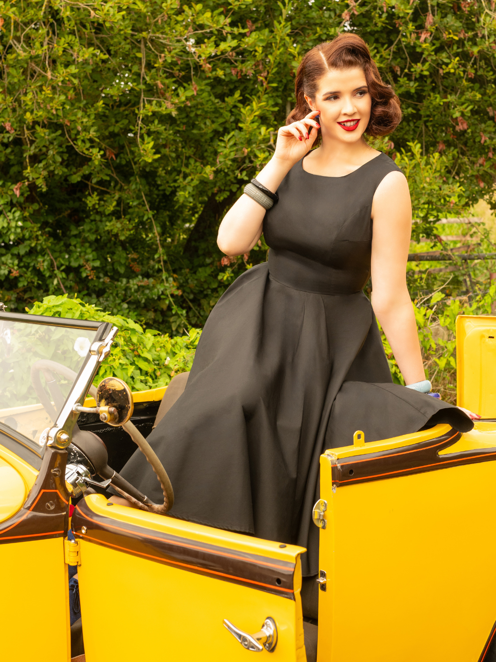 1950s black dress worn with blue belt 