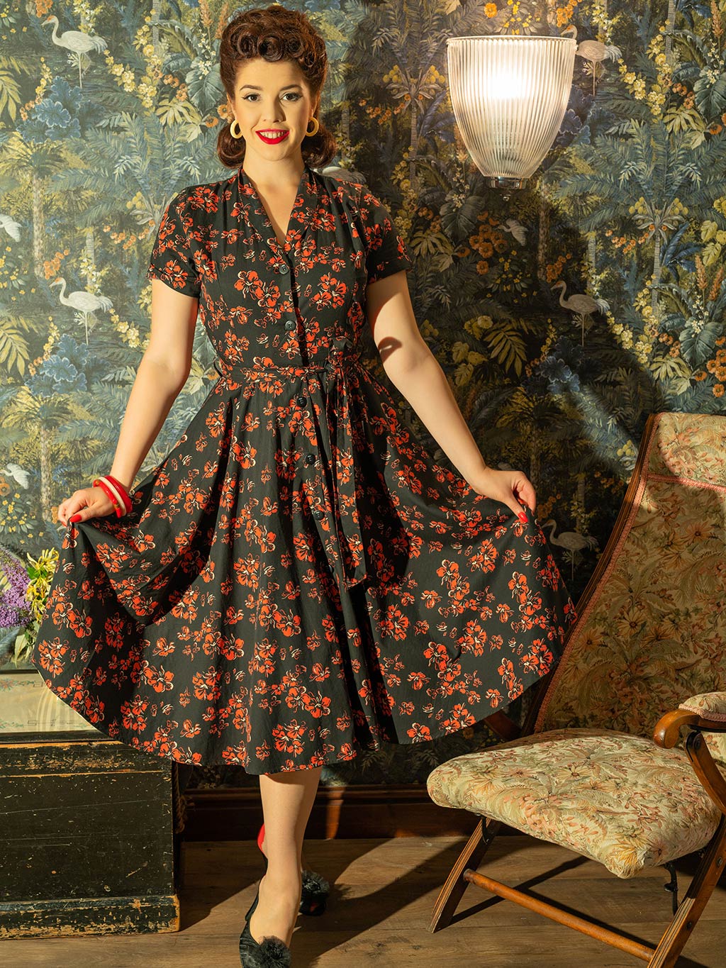 1950s shirtwaist dress in a red and cream floral print on black background