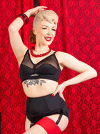 retro black bra worn with matching black suspender belt and stockings