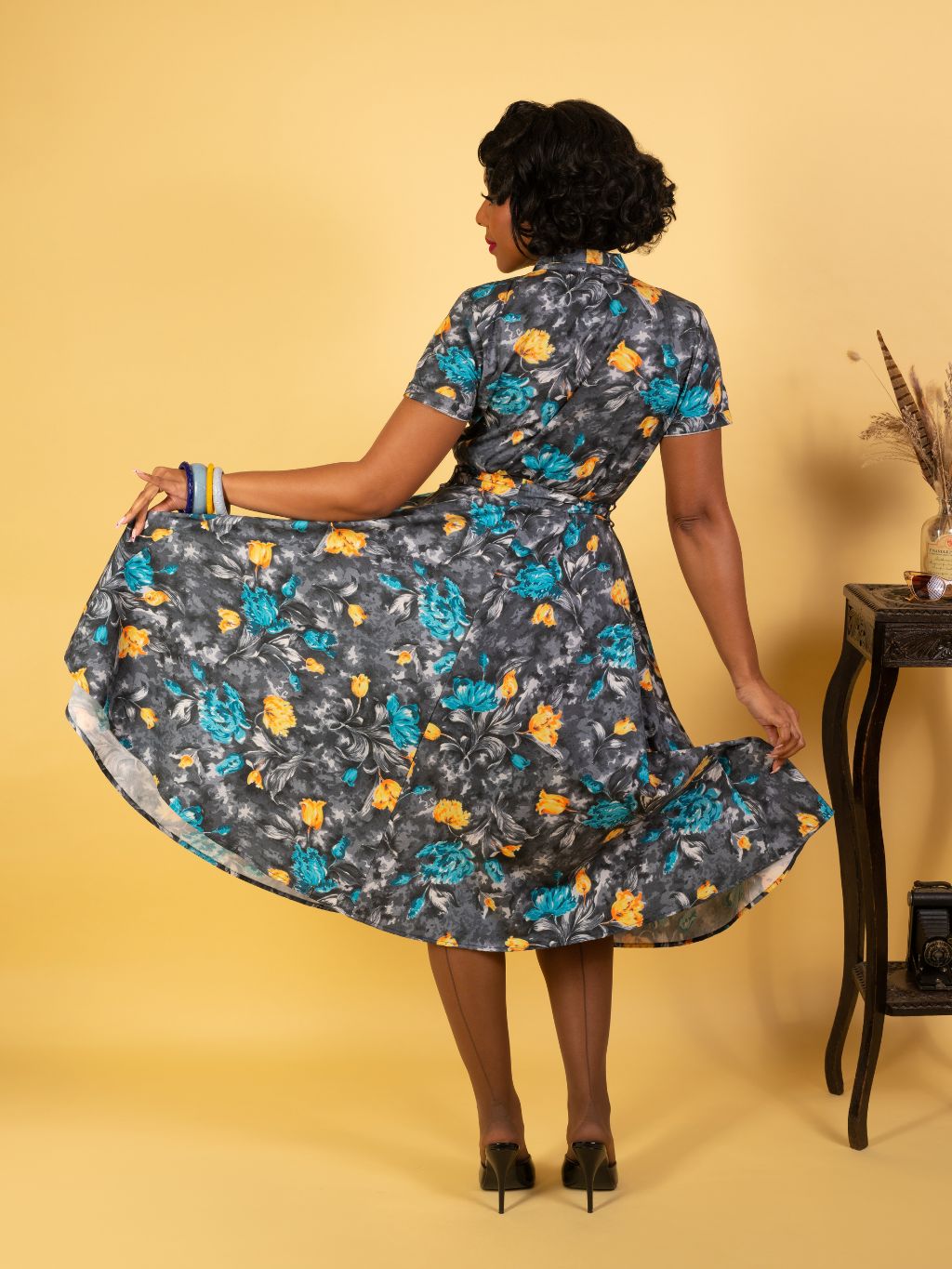 back view of retro 1950s grey dress with  floral print in burnt orange and turquoise