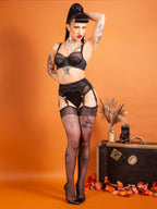 sheer black glossy stockings worn with black lingerie and high heeled shoes