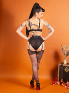 sheer black gloss stockings worn with black lingerie and high heel shoes