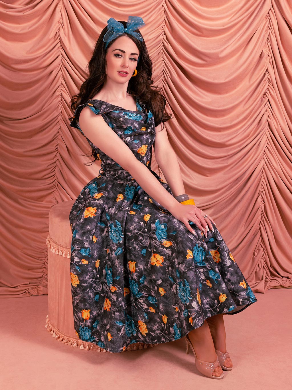 Side view of 1950s cowl neck dress showing fitted waist and full skirt