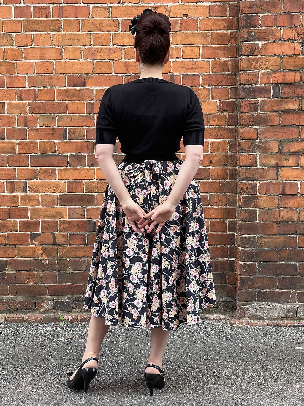 back view of a kimono print circle skirt worn with retro short sleeve jumper