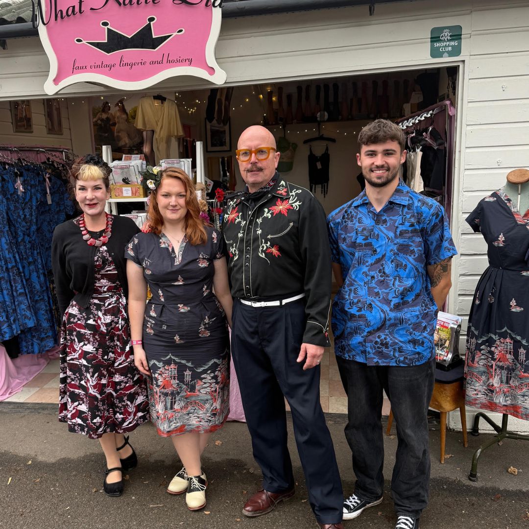 The What Katie Did team standing in front of their Goodwood Revival Pop Up vintage lingerie shop