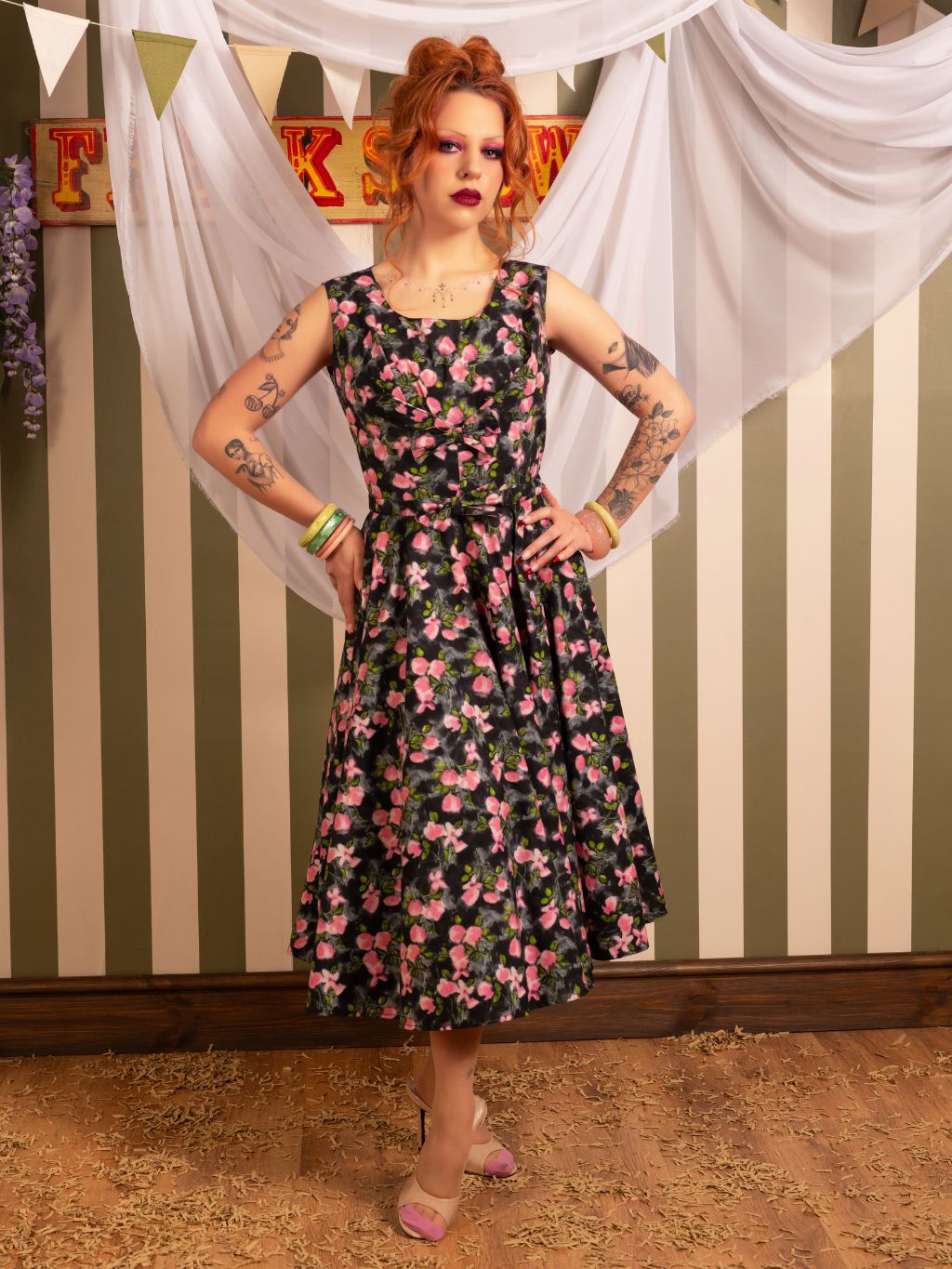 Discover our authentic Wilhelmina 1950s grey floral dress with full circle skirt, vintage bow detail, and practical pockets. Ethically made from premium 100% cotton with period-correct details. The perfect vintage-inspired wardrobe staple for timeless elegance.