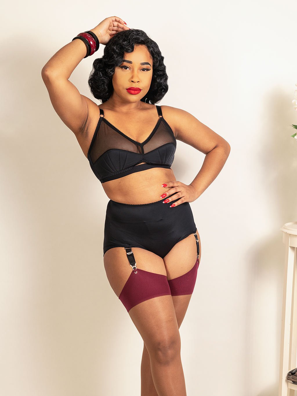Retro Liz lingerie by What Katie Did. Easy fit bra and suspender knickers in black recycled stretch fabric. Shop vintage inspired lingerie at What Katie Did.