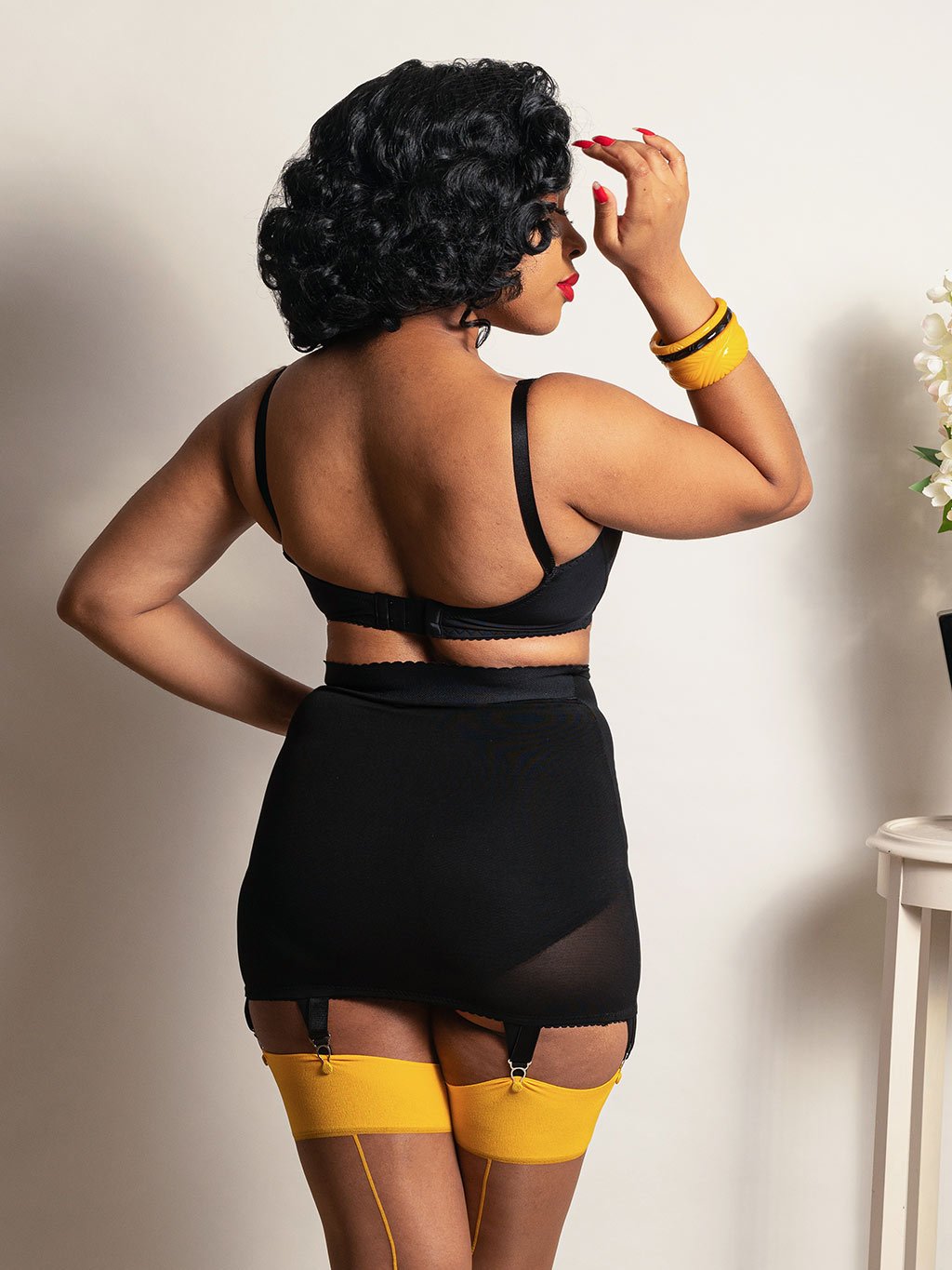 Trixie Firm Control Girdle in black powermesh. A roll on girdle that provides firm control and smoothing under clothing. 6 fixed suspender clips to keep your stockings in place.